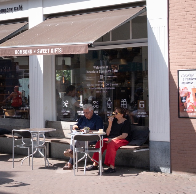 Two people sitting outside a chocolate cafe in Haarlem