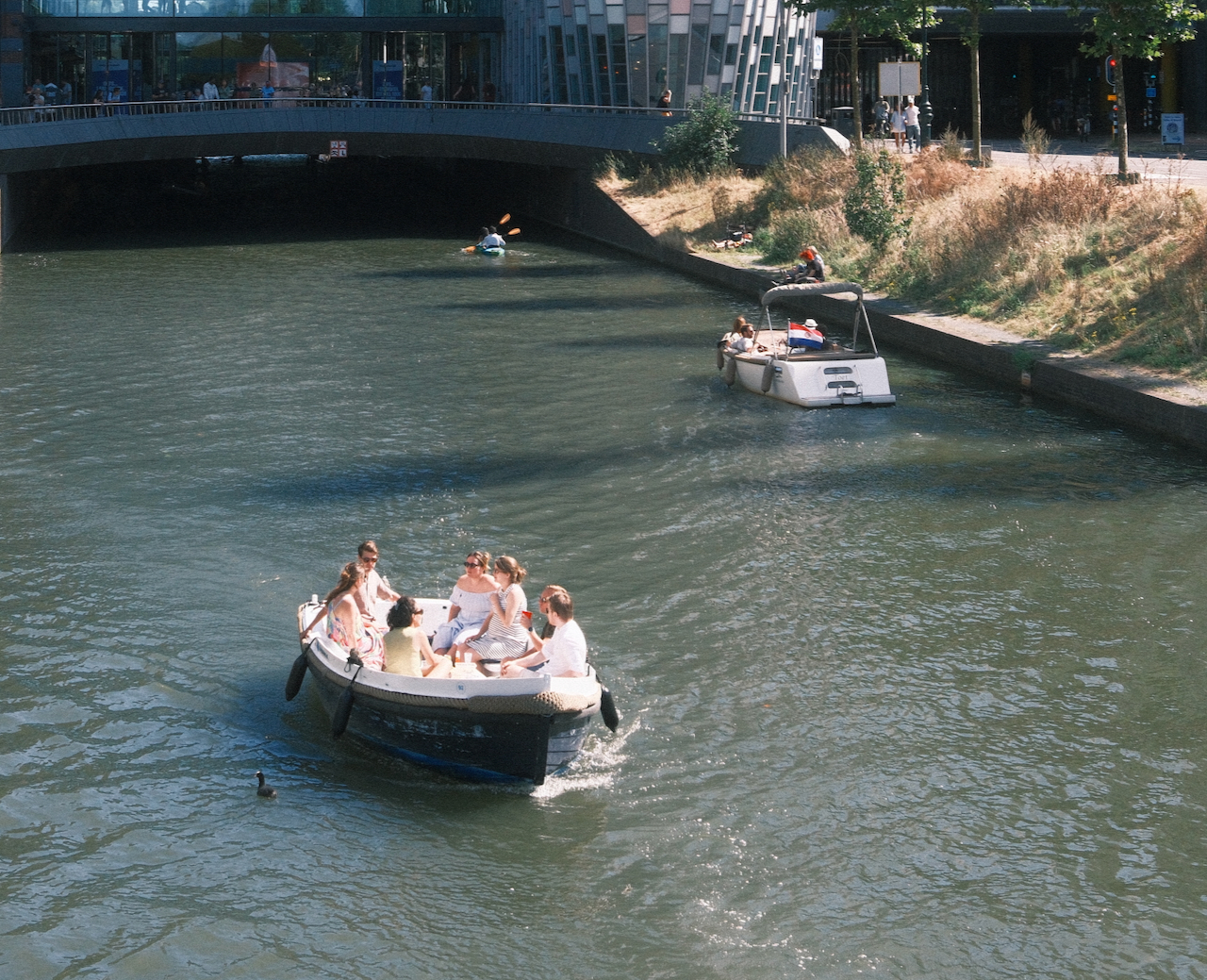 Small boats travelling along a broad Utrecht canal