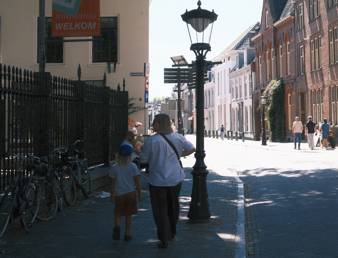 A family walking along a bright Utrecht street