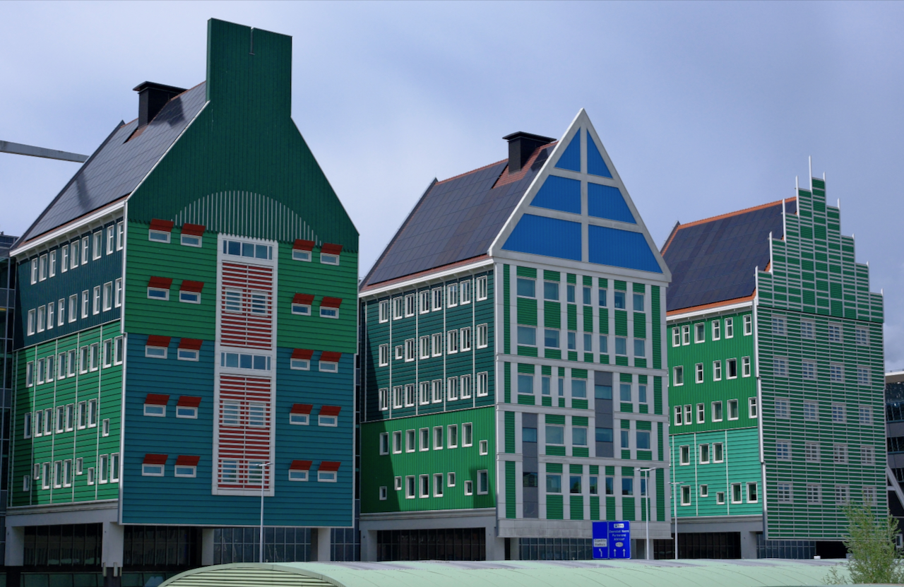 Large green hotel facades inspired by traditional Zaanse houses