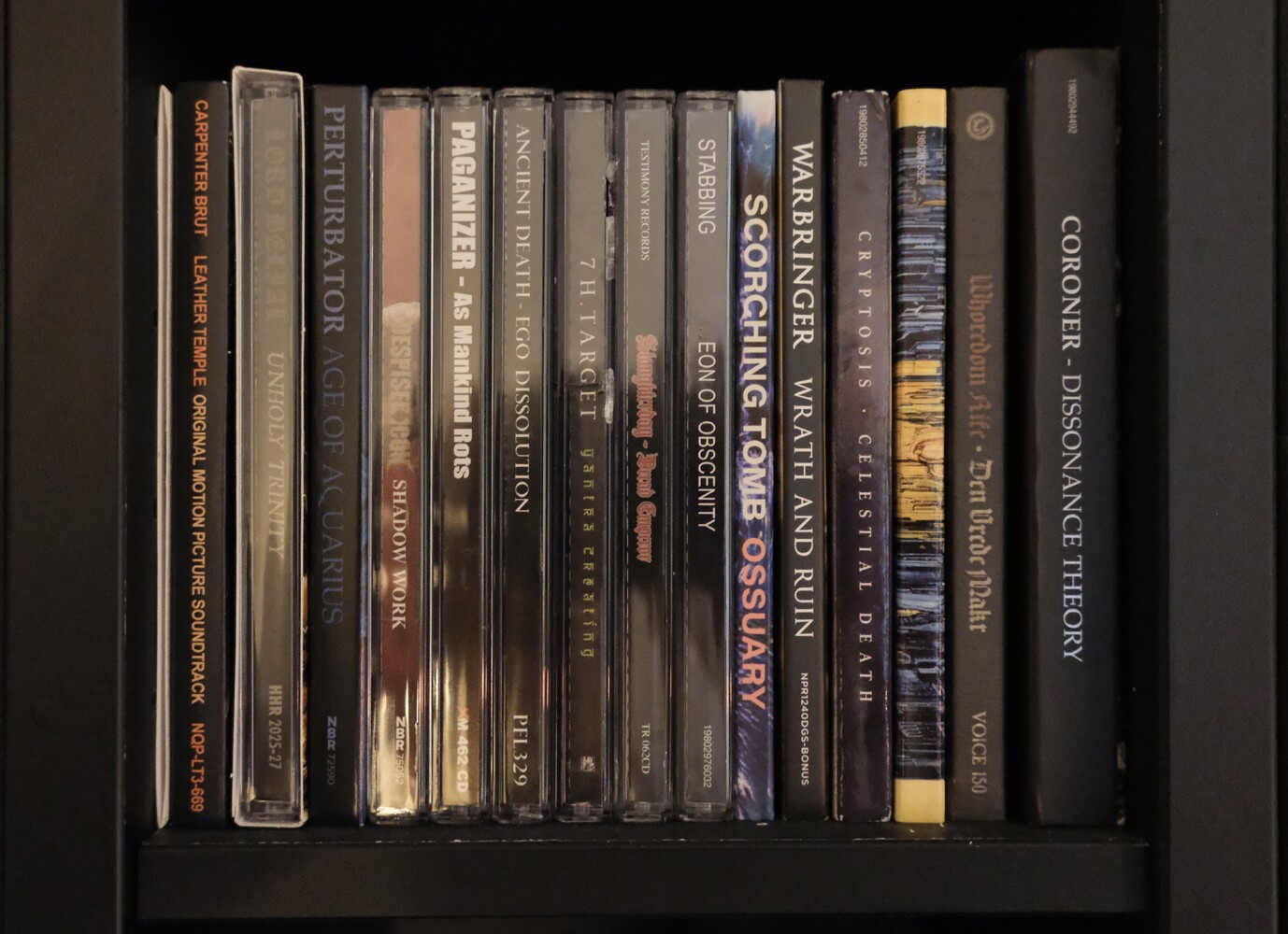 A shelf filled with metal albums on CD